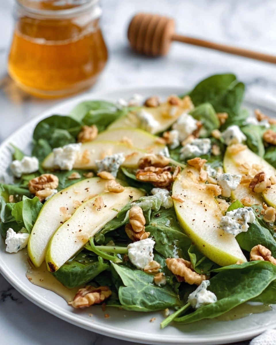 A white oval bowl filled with a fresh green salad, layered with thinly sliced green apples arranged neatly on top, scattered walnut pieces, crumbled white cheese, and fresh leafy greens covering the base. The bowl is placed on a white marbled surface, next to wooden salad serving spoons and a pear and lime partially visible nearby. The textures contrast between the crunchy apples, rough walnuts, soft cheese, and crisp greens, creating a colorful and fresh look. photo taken with an iphone --ar 4:5 --v 7