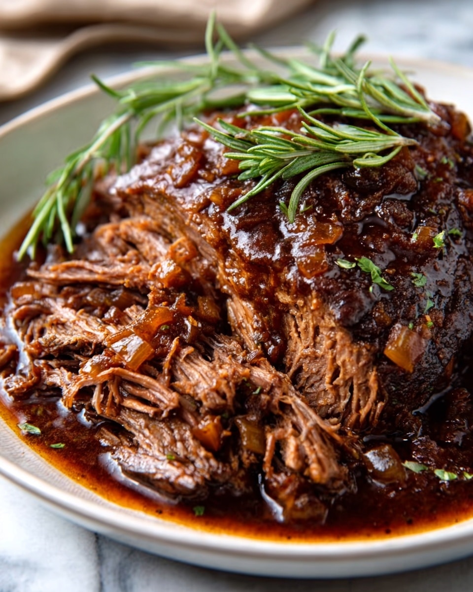 A close-up of a thick, tender piece of slow-cooked beef brisket sits in a white bowl, partially shredded to show soft and fibrous layers inside. The top layer has a dark brown, glossy crust with visible seasoning flakes, while the inside displays moist, medium-brown meat strands. The brisket is surrounded by a rich, dark brown sauce that glistens and pools around the meat, highlighting its juicy texture. The bowl rests on a white marbled surface, and a silver fork is visible in the background. photo taken with an iphone --ar 4:5 --v 7