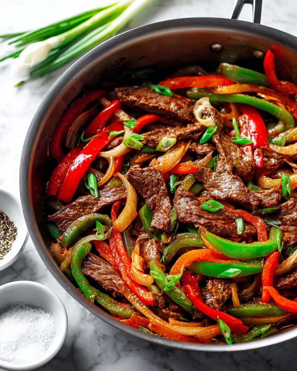 A plate of stir-fried beef and vegetables sits on a white marbled texture, placed on a red cloth with fringed edges. The dish has three main layers: the top layer is glossy, dark brown beef pieces coated in sauce, mixed evenly with bright green bell pepper slices and a few red chili strips. The middle layer is filled with golden-brown, slightly charred onion slices curled and mixed throughout. The bottom layer is the white plate with a blue patterned rim holding the food. Nearby, two yellow chopsticks rest on the left side with part of a small white bowl of sauce visible in the top right corner. photo taken with an iphone --ar 4:5 --v 7