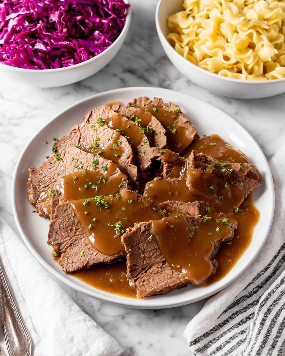 The image shows a white plate with a thick piece of roast beef cut into several slices, each covered in smooth brown gravy. The roast beef has a dark brown crust on the outside and a lighter brown inside, showing tender texture. The gravy glistens over the meat and pools slightly on the plate. Next to the beef is a small bunch of fresh green parsley. In the background, two white bowls hold side dishes, one with bright purple shredded cabbage and the other with creamy off-white mac and cheese topped lightly with green herbs. The setting is on a white marbled surface with a folded white and black striped cloth nearby. Photo taken with an iphone --ar 4:5 --v 7