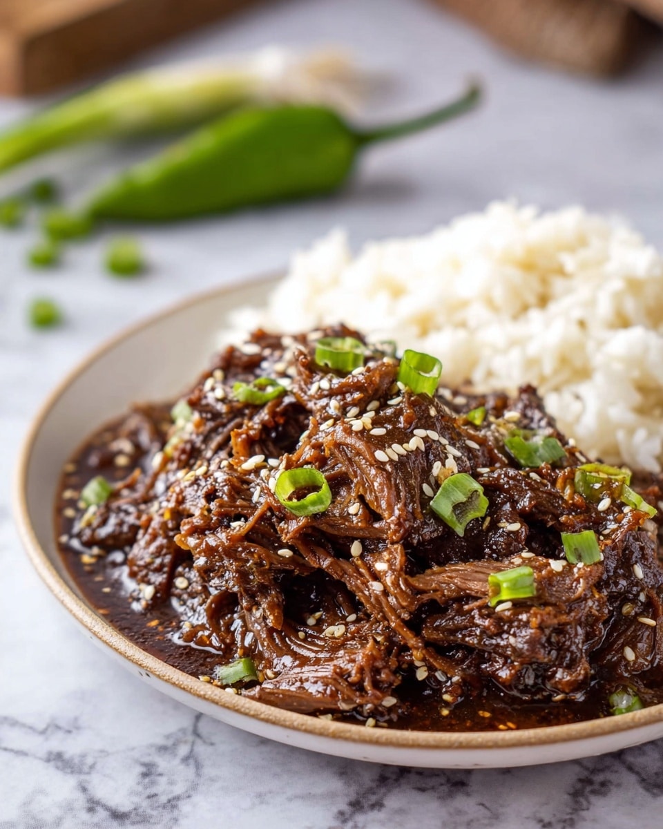 A shallow white bowl filled with dark brown, shredded beef in a thick glossy sauce, garnished with white sesame seeds and small green onion pieces scattered on top; a silver spoon rests in the bowl dipping into the tender beef chunks and rich sauce; the scene is set on a wooden surface with a blurred white marbled textured background and a few green onions placed in the back. photo taken with an iphone --ar 4:5 --v 7