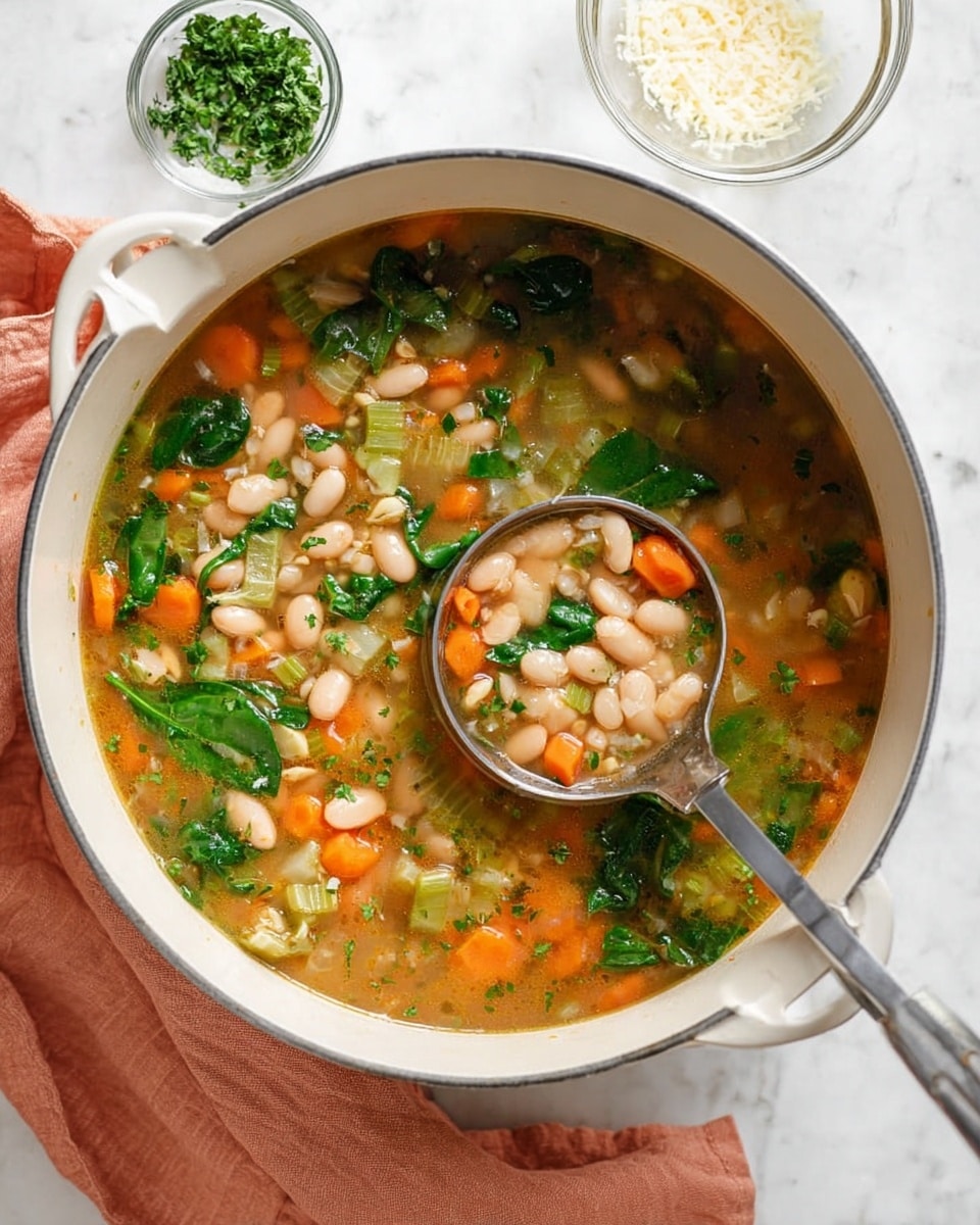 A white pot filled with a chunky vegetable and bean soup, showing three visible layers: light brown broth with small herbs on top, soft white beans scattered throughout, and bright orange diced carrots along with green celery and spinach leaves floating in the soup, with a silver ladle scooping a portion that highlights these colorful ingredients. The pot rests on a white marbled surface with a folded peach-colored cloth next to it, and small clear bowls containing chopped parsley and grated cheese in the upper background. Photo taken with an iphone --ar 4:5 --v 7