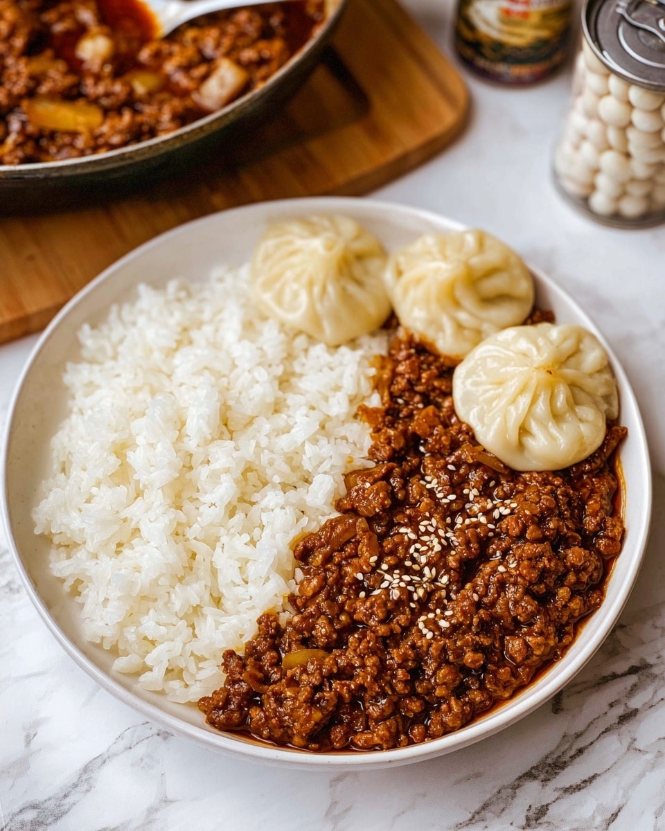 A red-handled white enamel pan filled with a thick layer of cooked ground meat mixed with diced garlic and covered in a rich, brown sauce with small bits of seasoning scattered throughout, placed on a wooden surface next to an open can filled with pale round slices, all set on a white marbled texture background with a white cloth nearby. photo taken with an iphone --ar 4:5 --v 7