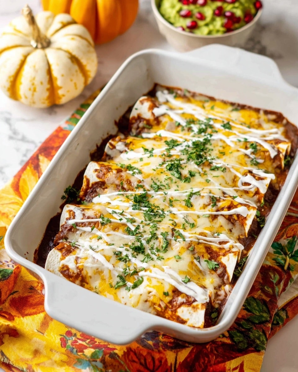 Two baked rolled tortillas are placed on a white plate, each topped with a golden-brown melted cheese layer with browned spots and some light green herb pieces scattered on top. A dollop of white sour cream is spread over the right tortilla. On the left tortilla, there is a bright green guacamole scoop sprinkled with shiny, red pomegranate seeds. In the background, a bowl filled with green guacamole and more red pomegranate seeds can be seen next to two small pumpkins on a white marbled surface. A white casserole dish with more food is also partially visible. Photo taken with an iphone --ar 4:5 --v 7
