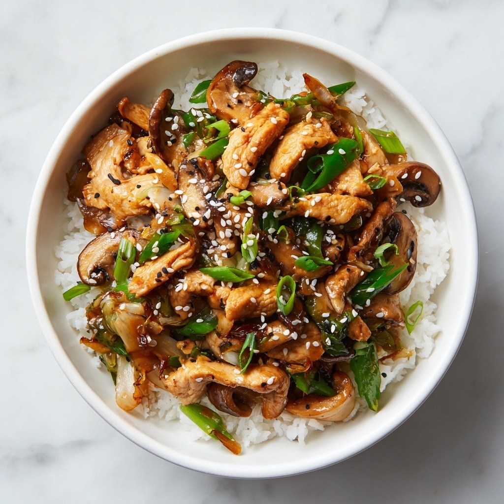 The close-up image shows a stir-fry dish in a black pan, containing multiple layers of food: the first layer has cooked chunks of light brown chicken pieces with a glossy texture, scattered unevenly; the second layer consists of dark brown sliced mushrooms with a moist, smooth surface; the third layer shows light green and white cabbage pieces, both chopped and slightly wilted; thin slices of translucent cooked onions add layers of pale yellow and off-white, mixed throughout; small black sesame seeds or similar garnish are sprinkled on top. A wooden spatula is partly visible stirring the ingredients. The dish is set against a white marbled texture background. photo taken with an iphone --ar 4:5 --v 7