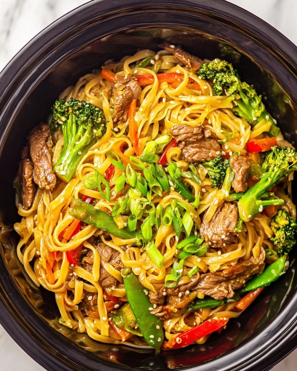 The image shows a close-up of a dish in a black bowl filled with wide, yellow noodles mixed with pieces of cooked brown beef, bright green broccoli florets, snap peas, thin orange carrot strips, and small red bell pepper chunks. The noodles and vegetables are coated in a light sauce, giving them a slight shine. The dish is topped with small white sesame seeds scattered throughout and chopped green onions adding a fresh green touch on top. The bowl rests on a white marbled surface. Photo taken with an iphone --ar 4:5 --v 7