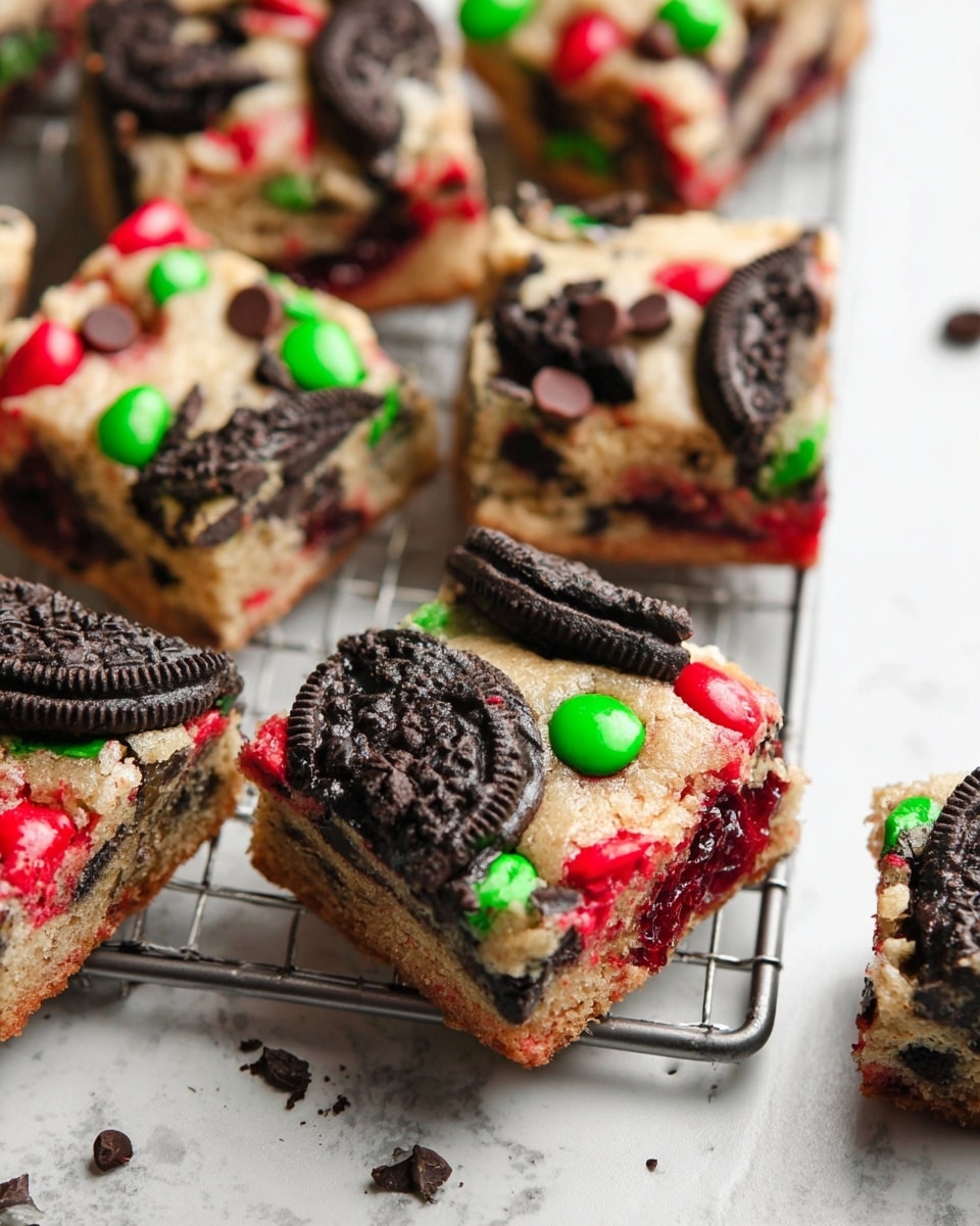 Nine square dessert bars are shown on a metal rack over a white marbled surface. Each bar has one thick layer of soft, light tan cookie dough studded with bright red and green candy-coated chocolates melted slightly into the surface, pieces of black sandwich cookie halves, and scattered dark chocolate chips, creating a colorful and textured top. Around the bars, several whole black sandwich cookies and a few chocolate chips are casually placed. The scene is bright with a close, top-down view. Photo taken with an iphone --ar 4:5 --v 7